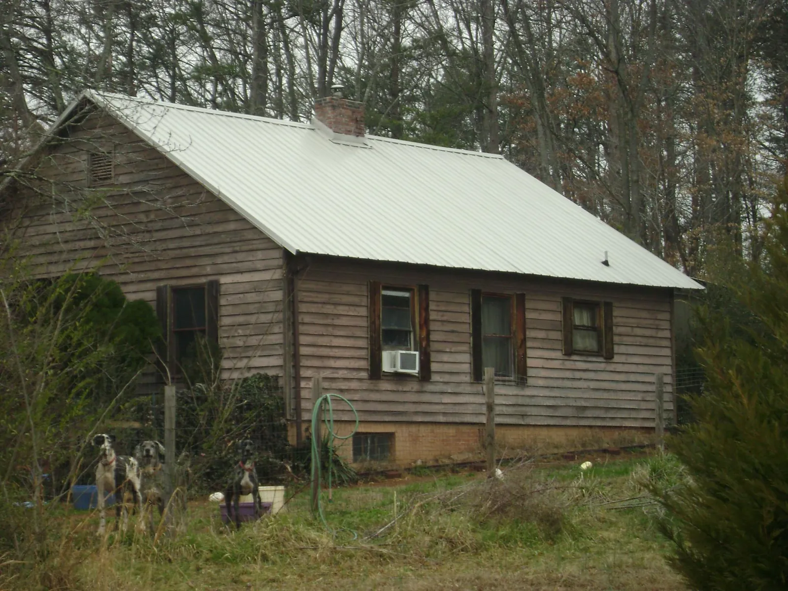 White metal roof on an old wood sided farmhouse, from a Metal Roof Installation job in Moulton